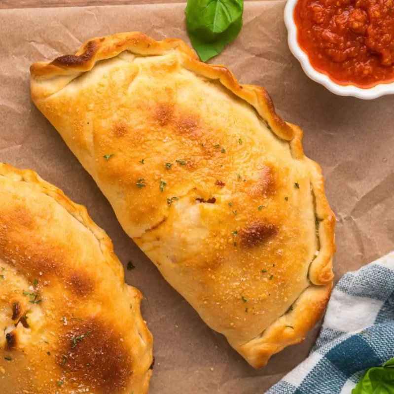 Calzone — folded pizza pocket stuffed with meats at Aladin's Pizzeria Winnipeg